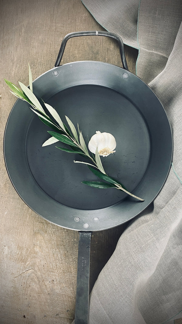 Large iron pan with hand-forged hook handle and counter handle