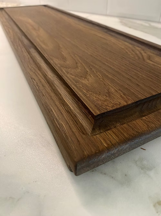Board made of solid oak in dark or natural with sap groove